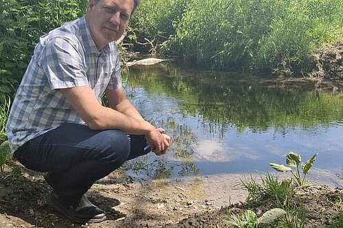 Paul Hartshorn looking sad near a stream