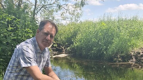 Paul Hartshorn looking sad near a stream